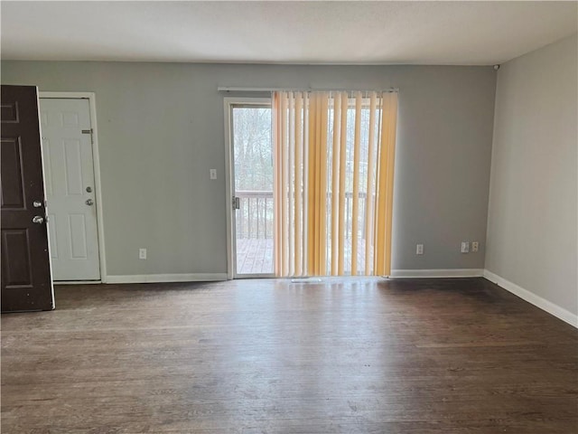 spare room with dark hardwood / wood-style floors