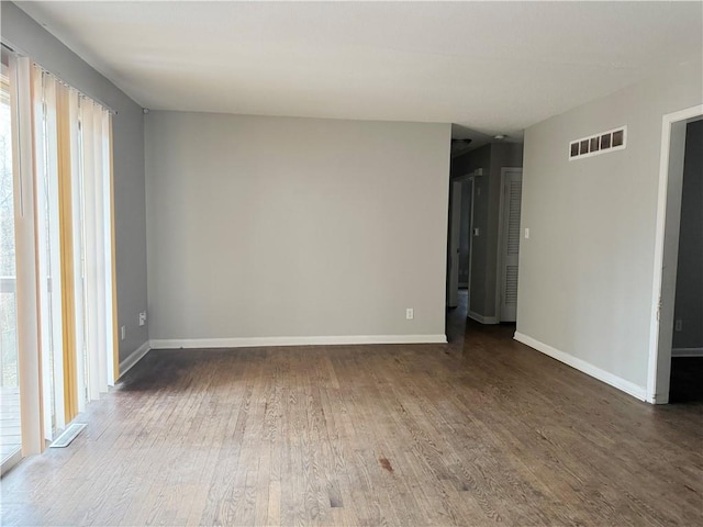 spare room featuring wood-type flooring