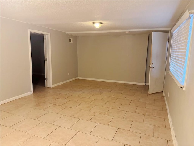 8618 E 32nd St, Kansas City, MO 64129 - spare room featuring a textured ceiling and baseboards