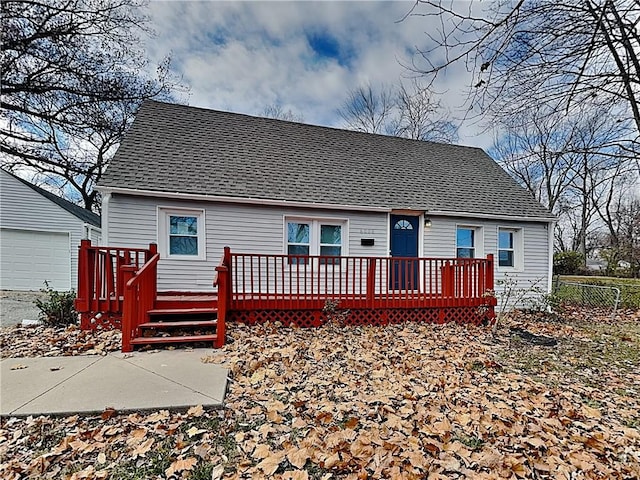 back of property with a garage and a deck