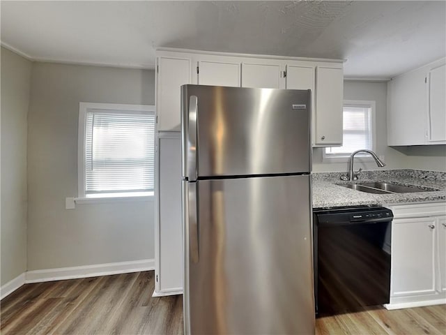 kitchen with white cabinetry, sink, stainless steel refrigerator, and dishwasher