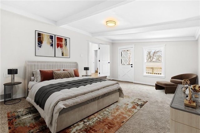 carpeted bedroom featuring beamed ceiling