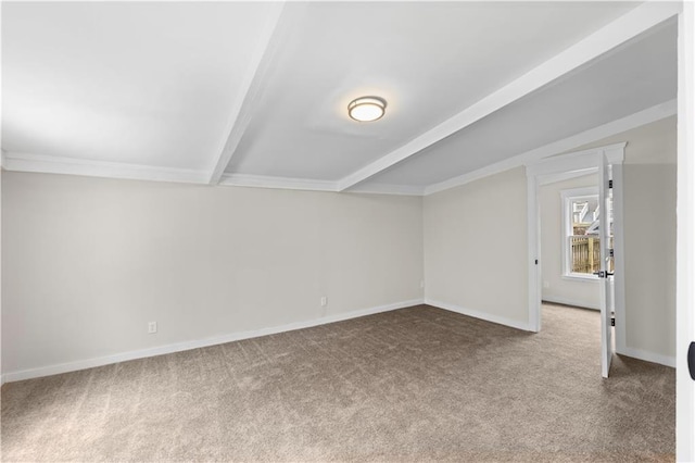 spare room featuring vaulted ceiling with beams and carpet flooring