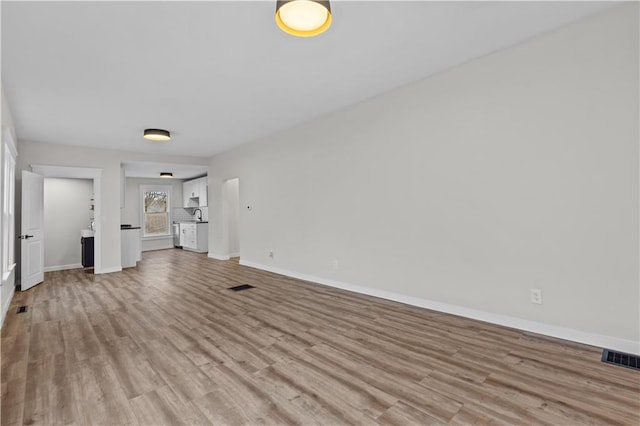 unfurnished living room with light wood-type flooring