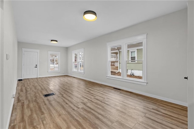 unfurnished room with light wood-type flooring