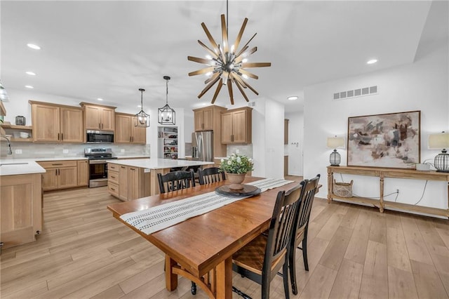 dining area with light wood-style floors, visible vents, and recessed lighting