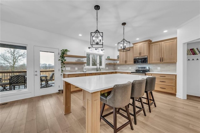 kitchen featuring open shelves, stainless steel appliances, tasteful backsplash, light countertops, and light wood-style floors