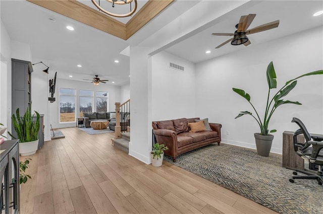 living room with light wood-style floors, stairs, visible vents, and recessed lighting