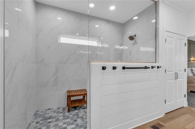 full bathroom with a marble finish shower, recessed lighting, visible vents, ensuite bath, and wood finished floors