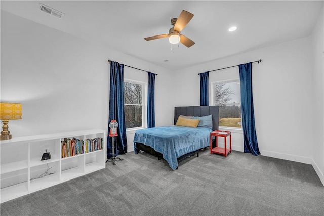 bedroom featuring carpet, multiple windows, visible vents, and baseboards