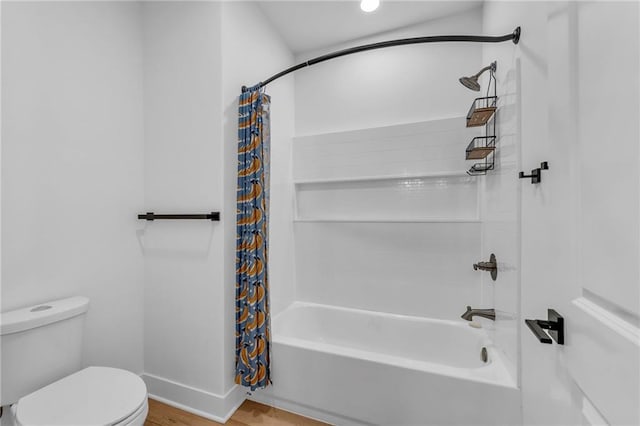 bathroom featuring shower / bath combination with curtain, toilet, and baseboards