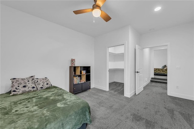 carpeted bedroom with ceiling fan, a spacious closet, recessed lighting, and baseboards