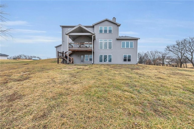 rear view of property with stairs, a lawn, and a chimney