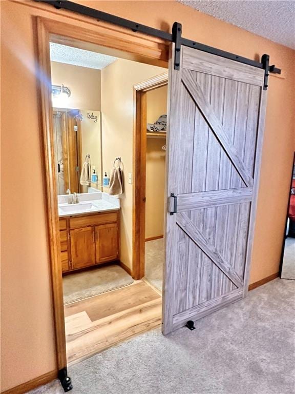 bathroom with vanity and a textured ceiling