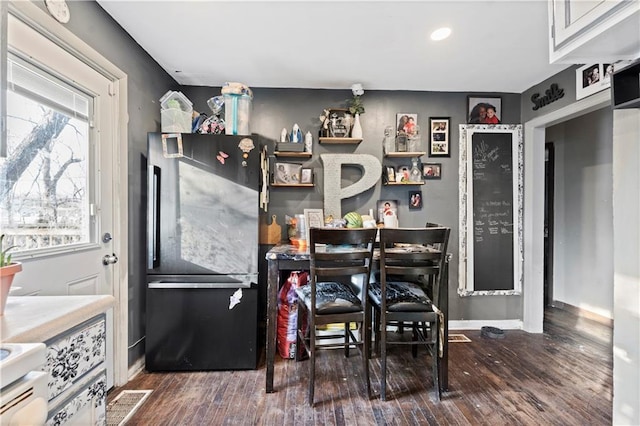 kitchen featuring black refrigerator and dark hardwood / wood-style floors