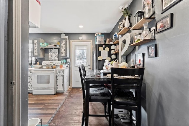 kitchen featuring dark wood-type flooring and white electric range oven