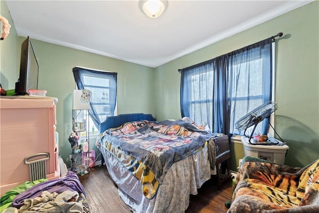 bedroom with dark hardwood / wood-style floors