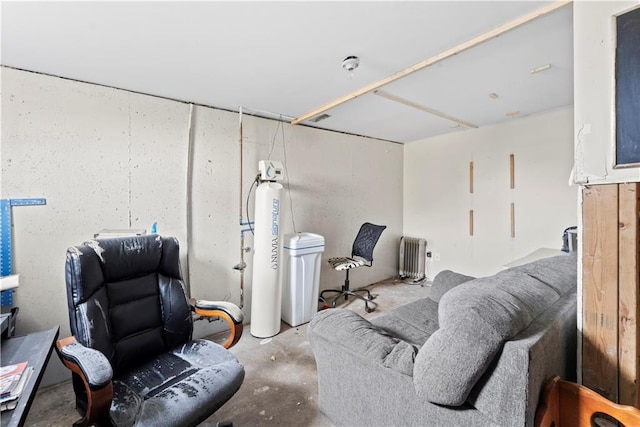 living area featuring radiator and concrete floors