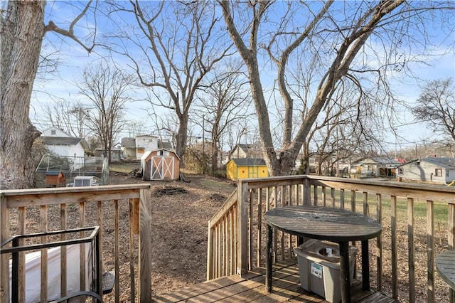 wooden deck featuring a storage unit