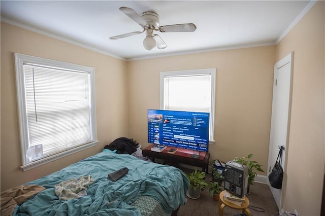 bedroom featuring ceiling fan, carpet, baseboards, and crown molding