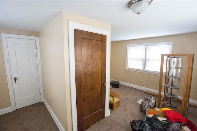 hall with carpet flooring and baseboards