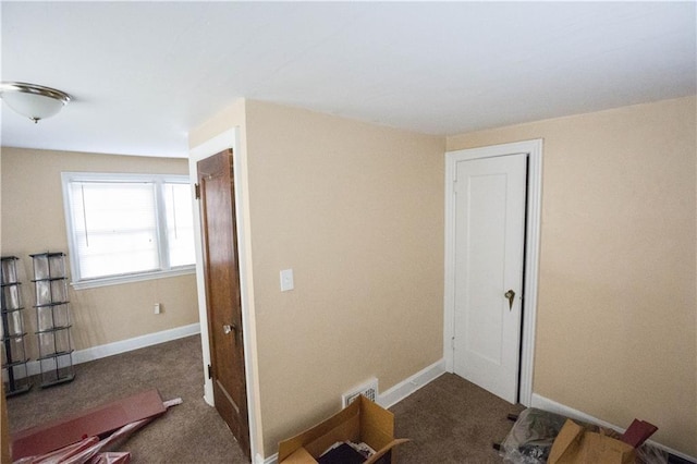 interior space with carpet, visible vents, and baseboards