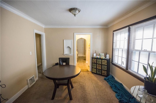 interior space featuring ornamental molding, carpet flooring, visible vents, and baseboards