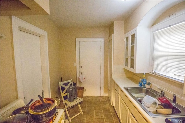 kitchen featuring light countertops and a sink