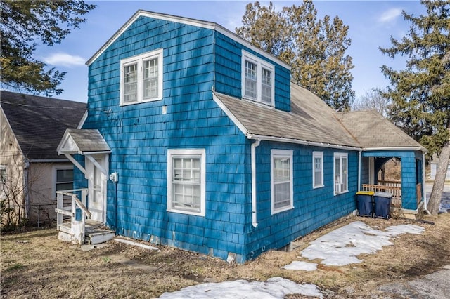 view of front of home with a shingled roof