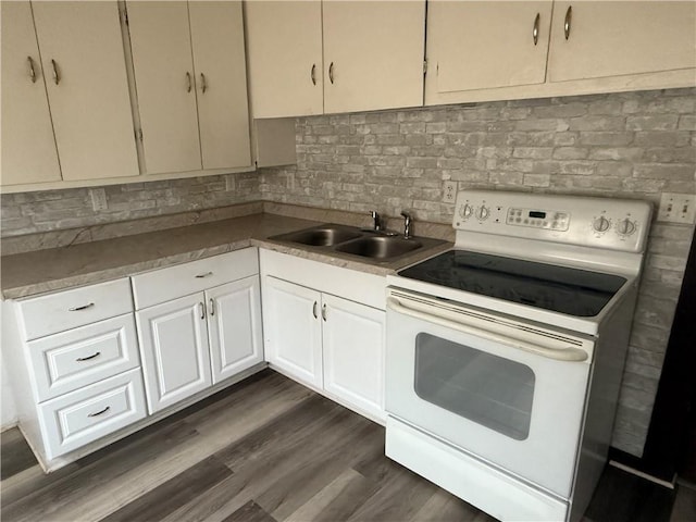 kitchen with sink, white cabinets, backsplash, white range with electric cooktop, and dark wood-type flooring