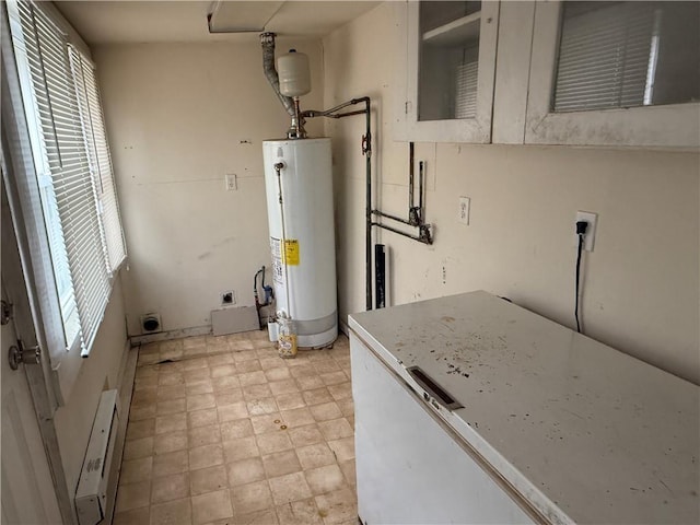 utility room with gas water heater and a baseboard radiator