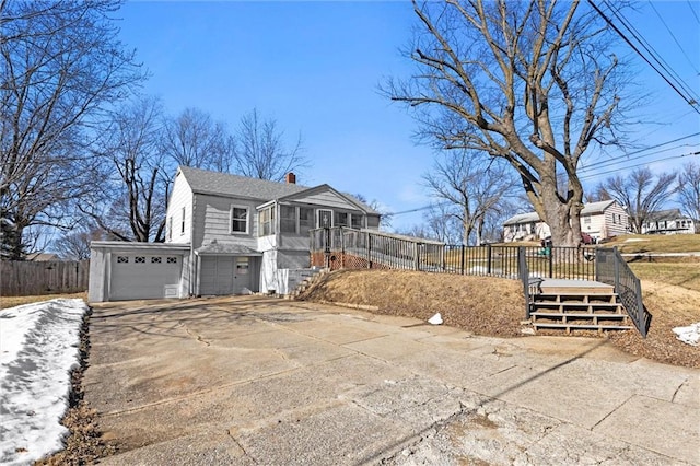 view of property exterior featuring a wooden deck and a sunroom