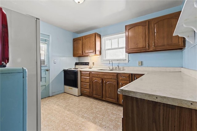 kitchen featuring sink and white electric range