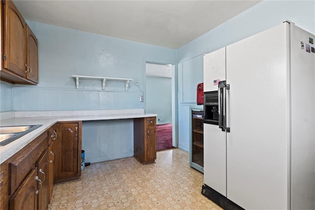 kitchen with white fridge with ice dispenser