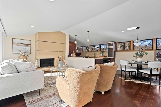 living room with hardwood / wood-style flooring and vaulted ceiling