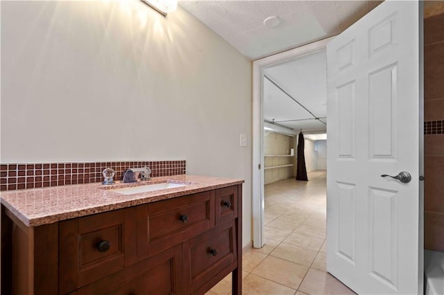 bathroom with sink, tile patterned floors, and decorative backsplash