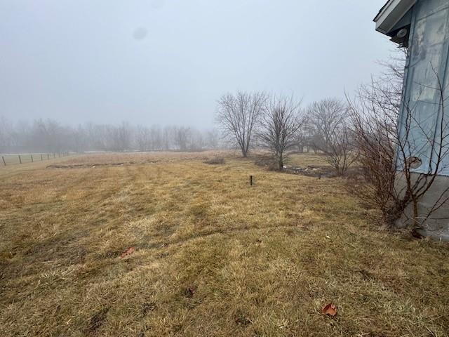 view of yard with a rural view