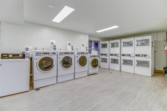 washroom with independent washer and dryer, stacked washer / dryer, and light hardwood / wood-style flooring