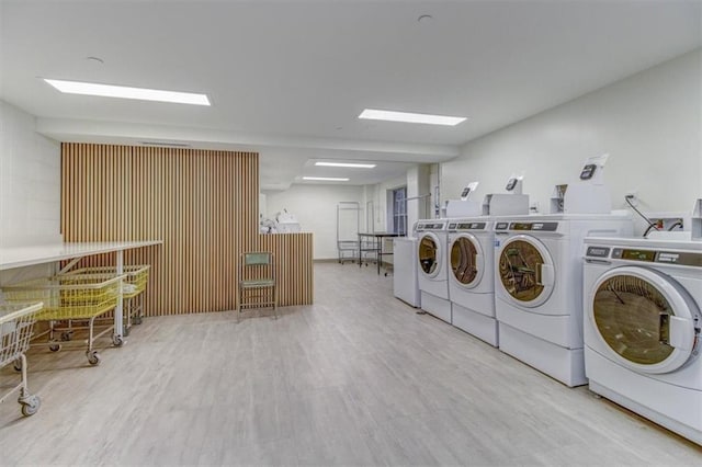 laundry room featuring washer and dryer and light wood-type flooring