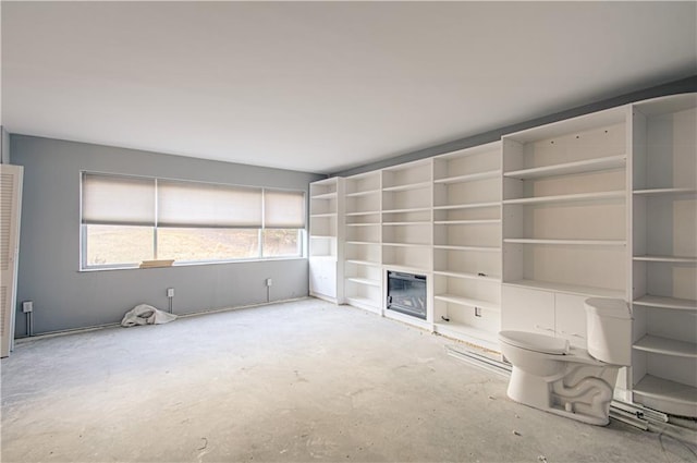 unfurnished living room with concrete floors