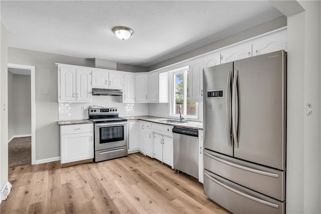 kitchen featuring white cabinetry, appliances with stainless steel finishes, sink, and tasteful backsplash