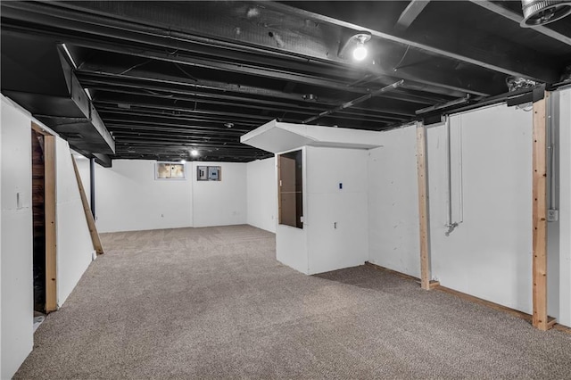 basement featuring light colored carpet