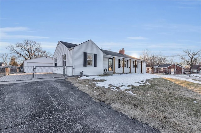 view of front of property with a garage and an outdoor structure