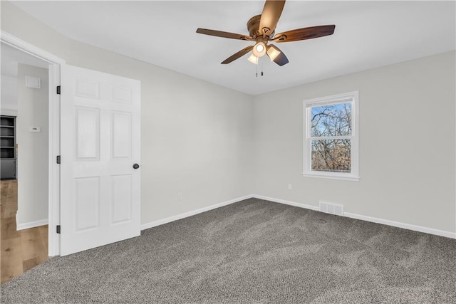 carpeted empty room with ceiling fan