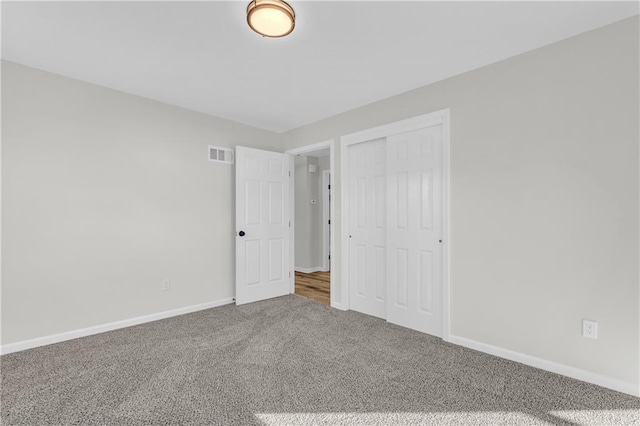 unfurnished bedroom with a closet and carpet