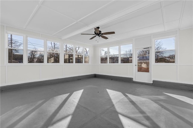 unfurnished sunroom with ceiling fan and plenty of natural light