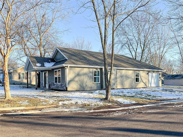 view of snow covered exterior with a garage