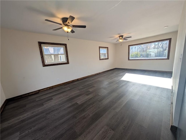 unfurnished room with ceiling fan and dark hardwood / wood-style flooring