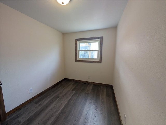 spare room with dark hardwood / wood-style flooring