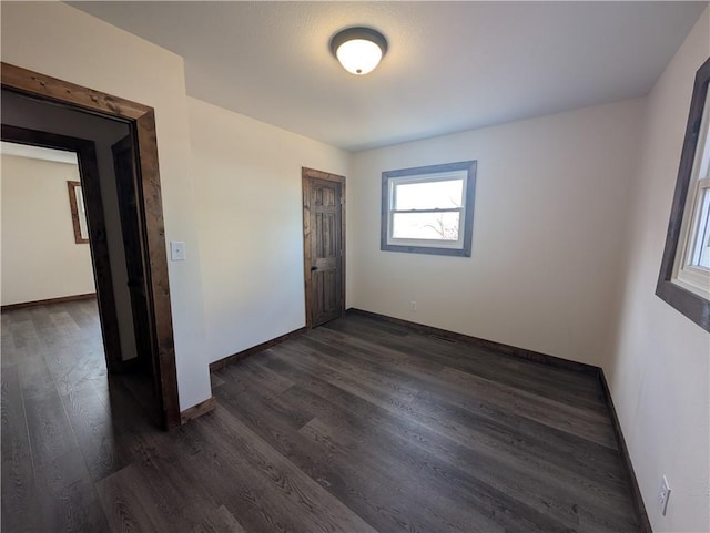 empty room featuring dark wood-type flooring